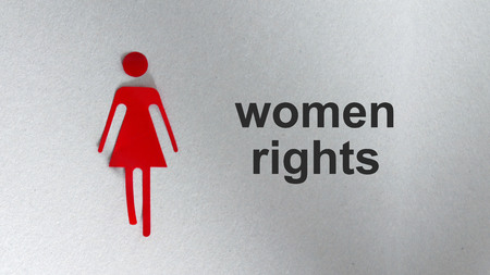 A silhouette of a red woman. The text Women's rightsの写真素材