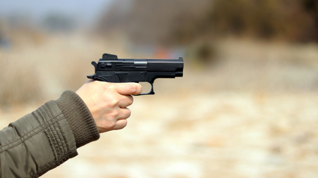 A hand with a gun.
