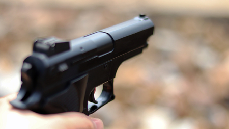 Close-up image of gun on the blur background.の写真素材