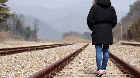 Appearance of a woman walking on the railroad track.の写真素材