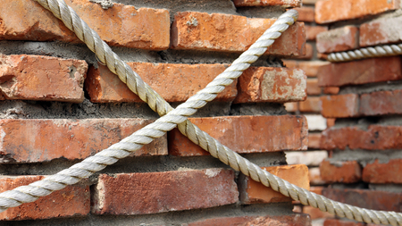 Close-up image of red brick walls and rope.の写真素材