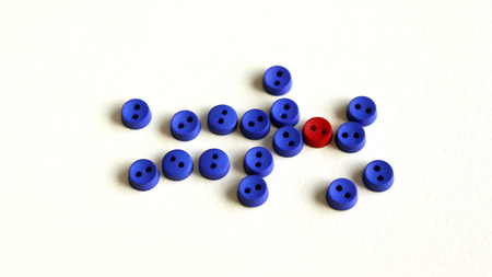 Several blue buttons and a red button between them.の写真素材