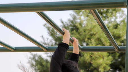 A boy's hand hanging from a cloud ladder.
