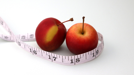 Two apples and a tape measure.の写真素材