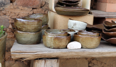 Traditional pottery on wooden shelves.