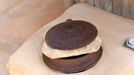 Close-up image of metal caldron lid.
