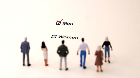 Men and Women check boxes with red check mark in the men box. Miniature people looking at the...