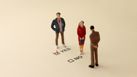 YES and NO check boxes with red check mark in the YES box. The concept of gender discrimination in the recruitment process.の写真素材