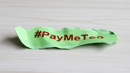 #PayMeToo as a new social movement. A piece of paper with #PayMeToo written on the floor.の写真素材