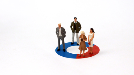 Two miniature men and two miniature women are standing on a donut graph. The concept of the gender recruitment gap.の写真素材