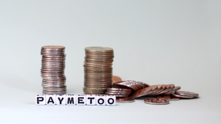 #PayMeToo as a new campaign to close the wage gap between men and women. White cube as #PayMeToo and coins.の写真素材
