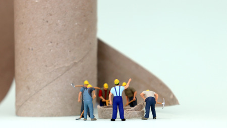 Miniature people working on construction site. The concept of daily labor life.の写真素材