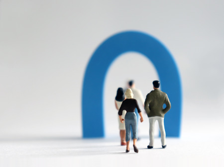 The miniature people lined up in front of a small gate. A poor concept in the job market.の写真素材