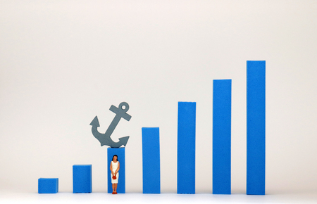 Blue bar graph and miniature woman. An invisible barrier concept that exists in women.の写真素材