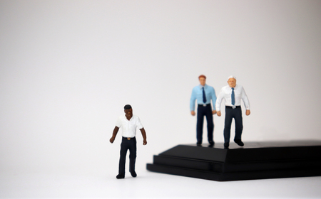 The social problem concept of racism. Miniature people of different races.の写真素材