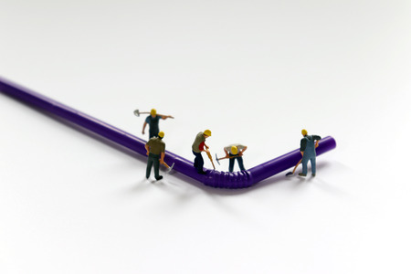 Disposable straws and miniature workers.の写真素材