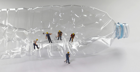 A plastic bottle and miniature people.の写真素材
