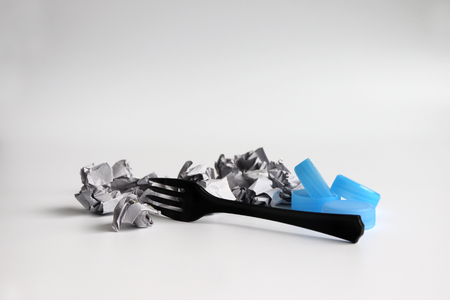 Crumpled paper waste and disposable plastic products.