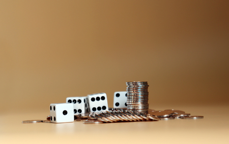 Coins with white dice.の写真素材
