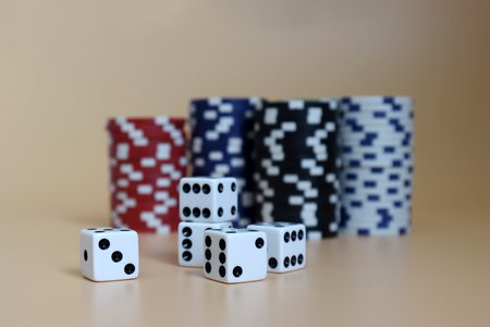 Five dice with the pile of casinos chips.の写真素材