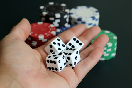 The palm of the woman is the dice with the casino chips.の写真素材