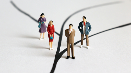 Two miniature men and two miniature women.の写真素材