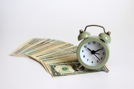 An alarm clock on the US dollar.の写真素材