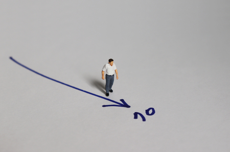 A middle-aged miniature man standing before the number 70.の写真素材