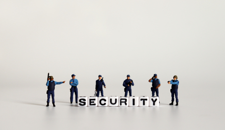 SECURITY word written in white cube. Miniature combat police with letter cubes.の写真素材