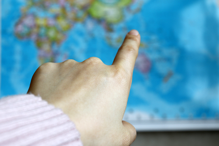 The index finger of a woman pointing at the map.の写真素材