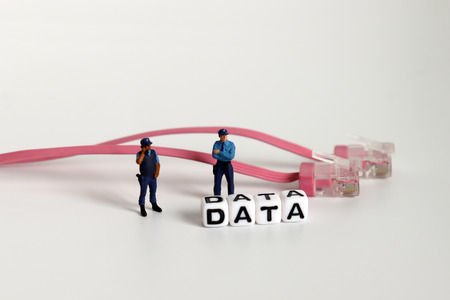 DATA text on white cube. Miniature people and Network internet cable.の写真素材