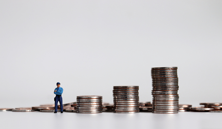 Three piles of coins and miniature police.の写真素材