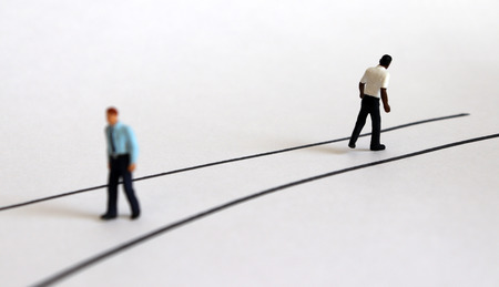 Miniature people walking in different directions.の写真素材