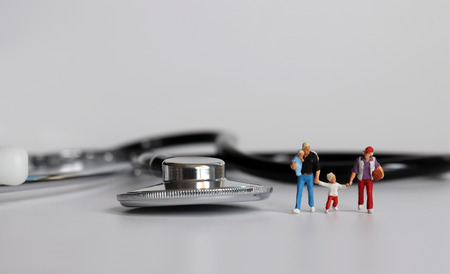 A family of four miniatures with stethoscope.の写真素材