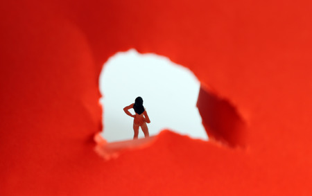 The concept of a sneaking glance at women. Miniature woman.の写真素材