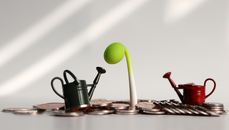 Two miniature watering can and a miniature bud on top of the coins.の写真素材