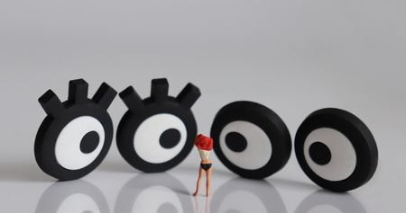 A miniature woman changing clothes and miniature eyes.の写真素材