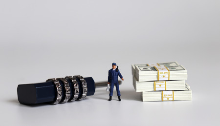 The bundle of bills and a combination lock. Miniature people.