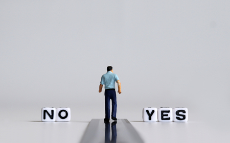 YES and NO text alphabet white cube. Miniature people.の写真素材