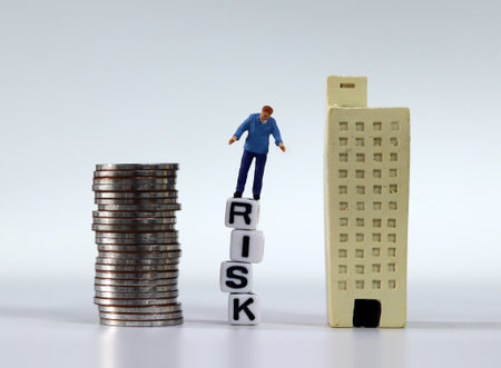 Risk management concept. Miniature man standing on the white cubes with RISK word. Miniature and a pile of coins.の写真素材