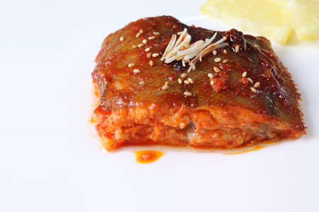 Fish boiled in spiced gochujang sauce. Braised place using spicy sauce.