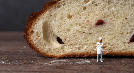 Roasted bread and a miniature chef. Miniature people and business concept.