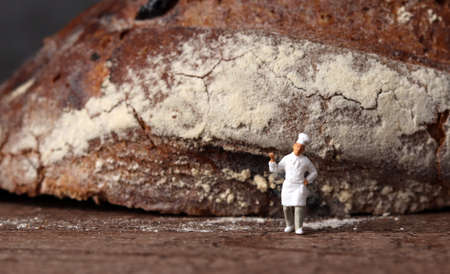Roasted bread and a miniature chef. Miniature people and business concept.