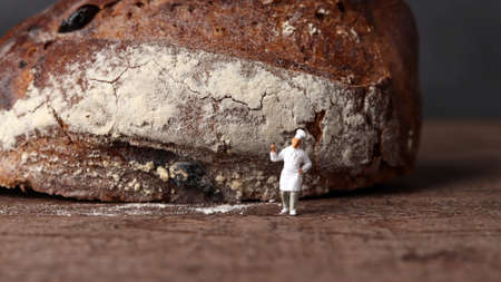 Roasted bread and a miniature chef. Miniature people and business concept.
