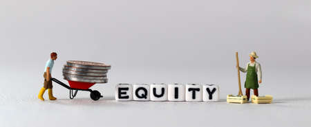 White cube with the word 'EQUITY'. Pile of coins and miniature people with business concept.の写真素材