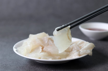 A close-up image of fresh flatfish sashimi. A fresh raw fish dish that goes well with alcohol during Korean cuisine.の写真素材