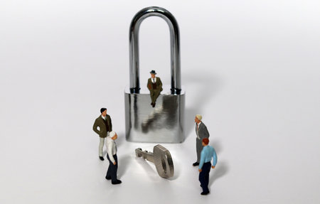 Security key and miniature entrepreneur against white background. Meeting for Lockdown...