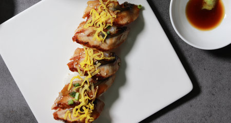 Eel sushi with egg garnish on top. A close-up shot of fresh seafood dishes.の写真素材