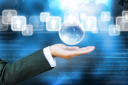hand of business women pushing world and a button on a touch screen interfaceの写真素材