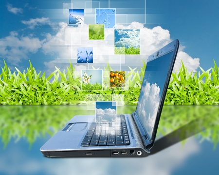 notebook and button a touch screen interface against sky backgroundの写真素材